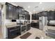 Elegant kitchen with stainless steel appliances, granite countertops, and dark wood cabinets at 11802 Twilight Darner Pl, Riverview, FL 33569