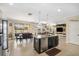 Open-concept kitchen with an island that flows into a dining area and living space at 11802 Twilight Darner Pl, Riverview, FL 33569