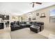 Spacious living room features a comfortable sectional sofa, ceiling fan, and modern decor at 11802 Twilight Darner Pl, Riverview, FL 33569