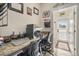 Inviting home office with granite counters, neutral walls, and natural light from the entryway in the background at 11802 Twilight Darner Pl, Riverview, FL 33569