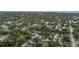 This is an aerial view of the property, nestled among lush green trees, with the waterfront viewable in the distance at 1211 14Th N St, St Petersburg, FL 33705