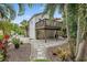 Beautiful backyard with stone pavers, tropical landscaping, and the wooden back deck is attached to the home at 1211 14Th N St, St Petersburg, FL 33705