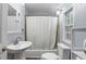 Cozy bathroom with a shower-tub combo and pedestal sink with a matching mirror at 1211 14Th N St, St Petersburg, FL 33705