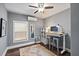 Bright bedroom with a standing desk, ceiling fan, and natural light from a window at 1211 14Th N St, St Petersburg, FL 33705