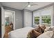 Bright bedroom with hardwood floors, neutral walls, ceiling fan, and a large window for natural light at 1211 14Th N St, St Petersburg, FL 33705