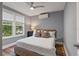 Bright bedroom with hardwood floors, neutral walls, ceiling fan, and a large window for natural light at 1211 14Th N St, St Petersburg, FL 33705