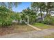 Charming home with mature tropical landscaping and a walkway leading to the inviting, covered front porch at 1211 14Th N St, St Petersburg, FL 33705
