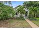 Charming home with mature tropical landscaping and a walkway leading to the inviting, covered front porch at 1211 14Th N St, St Petersburg, FL 33705
