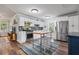 Bright kitchen featuring white cabinets, stainless appliances, and an island table at 1211 14Th N St, St Petersburg, FL 33705