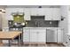 Clean kitchen features white cabinets, stone countertops, stainless steel appliances, and tile backsplash at 1211 14Th N St, St Petersburg, FL 33705