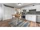 Inviting kitchen featuring ample cabinetry, a center island with seating, and stainless steel appliances at 1211 14Th N St, St Petersburg, FL 33705