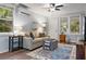 Comfortable living room with hardwood floors, a ceiling fan, and a large window for natural light at 1211 14Th N St, St Petersburg, FL 33705