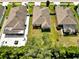 Overhead view of a residential area with well-kept lawns and neighboring houses at 12428 Chaya Ct, Spring Hill, FL 34610
