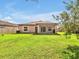 Spacious backyard with a well-manicured lawn and a lovely view at 12428 Chaya Ct, Spring Hill, FL 34610