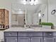 Bathroom features a granite countertop vanity with a large mirror and storage cabinets at 12428 Chaya Ct, Spring Hill, FL 34610
