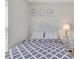 Bright bedroom showcasing natural light, neutral decor, and laminate wood flooring at 12428 Chaya Ct, Spring Hill, FL 34610