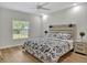 Relaxing bedroom features ceiling fan, neutral decor and bright light at 12428 Chaya Ct, Spring Hill, FL 34610