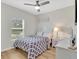 Bright bedroom showcasing natural light, neutral decor, and laminate wood flooring at 12428 Chaya Ct, Spring Hill, FL 34610