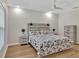 Bright bedroom with hardwood flooring, ceiling fan, and a wooden headboard at 12428 Chaya Ct, Spring Hill, FL 34610