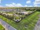 Aerial view of a community entrance, showcasing landscaping and amenities like a pool at 12428 Chaya Ct, Spring Hill, FL 34610