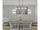 Cozy dining room featuring modern chandelier and stylish decor at 12428 Chaya Ct, Spring Hill, FL 34610