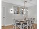 Bright dining room with modern chandelier and stylish wall art at 12428 Chaya Ct, Spring Hill, FL 34610