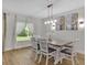 Inviting dining room with a modern chandelier, natural light, and table at 12428 Chaya Ct, Spring Hill, FL 34610