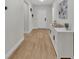 Bright entryway showcasing hardwood floors, neutral walls, and a white front door for a welcoming ambiance at 12428 Chaya Ct, Spring Hill, FL 34610