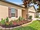 Close up of a home featuring a well-manicured lawn and a two-car garage at 12428 Chaya Ct, Spring Hill, FL 34610