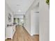 Bright hallway with light wood floors leading to living areas at 12428 Chaya Ct, Spring Hill, FL 34610