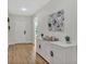 Inviting hallway with light wood floors and white console table at 12428 Chaya Ct, Spring Hill, FL 34610