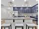 Open kitchen with granite countertops, a center island, seating, stainless steel appliances, and stylish pendant lighting at 12428 Chaya Ct, Spring Hill, FL 34610