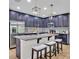 Modern kitchen featuring dark cabinets, granite countertops, stainless appliances, a center island with seating, and pendant lighting at 12428 Chaya Ct, Spring Hill, FL 34610