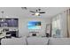 Comfortable living room with a cozy sofa, shiplap wall, and kitchen view at 12428 Chaya Ct, Spring Hill, FL 34610