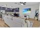 Cozy living room featuring a sectional sofa, shiplap wall, and modern kitchen at 12428 Chaya Ct, Spring Hill, FL 34610