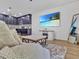 Comfortable living room with cozy sofa, kitchen, rug, and beach view TV at 12428 Chaya Ct, Spring Hill, FL 34610
