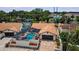 Aerial view of a home showcasing a private screened-in pool, brick driveway, and manicured landscaping at 13544 Avista Dr, Tampa, FL 33624
