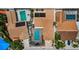 Aerial view showcasing a home with a screened pool, solar panels, lush landscaping, and brick driveway at 13544 Avista Dr, Tampa, FL 33624