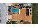 Aerial view of a home featuring a private pool with screen enclosure, a brick driveway, and manicured landscaping at 13544 Avista Dr, Tampa, FL 33624