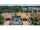 Aerial view of homes with screened-in pools, tile roofs, and lush landscaping at 13544 Avista Dr, Tampa, FL 33624