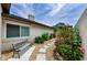 Serene backyard featuring a stone walkway, flourishing landscaping, a comfortable bench, and privacy wall at 13544 Avista Dr, Tampa, FL 33624