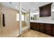 Bright bathroom featuring tile floors and a glass shower with decorative tile and shower head at 13544 Avista Dr, Tampa, FL 33624