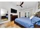 Primary bedroom with travertine floors, ceiling fan, and a view to the pool area at 13544 Avista Dr, Tampa, FL 33624