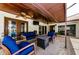 Relaxing covered patio with cozy seating, ceiling fans, and a stone-topped coffee table at 13544 Avista Dr, Tampa, FL 33624