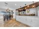 Dining area adjacent to an island with seating and views of the backyard at 13544 Avista Dr, Tampa, FL 33624