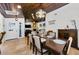 Dining room with wood ceiling, view into the living room, and travertine floors at 13544 Avista Dr, Tampa, FL 33624
