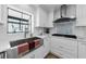 Close up of the bright kitchen featuring white cabinets, backsplash, and countertops at 13544 Avista Dr, Tampa, FL 33624