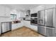 Modern kitchen with stainless steel appliances, white cabinetry, and a farmhouse sink at 13544 Avista Dr, Tampa, FL 33624