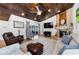 Spacious living room with wood ceiling, stone fireplace, and travertine floors at 13544 Avista Dr, Tampa, FL 33624