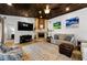 Comfortable living room boasts a wood-paneled ceiling, stone fireplace, and media center at 13544 Avista Dr, Tampa, FL 33624